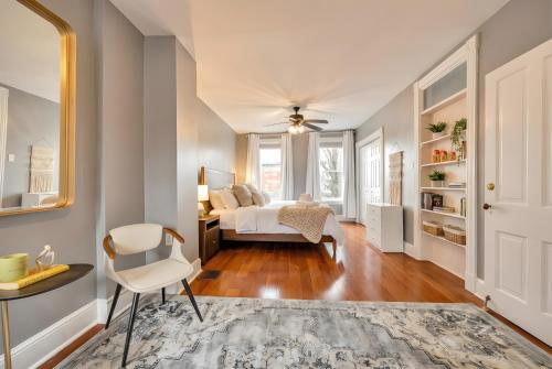 a bedroom with a bed and a table and a chair at Downtown Lancaster Luxury 4BR - Garage & Parking in Lancaster