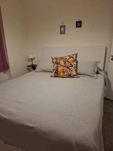 a bed with a pillow on top of it at Villa Sofia in Foz do Arelho