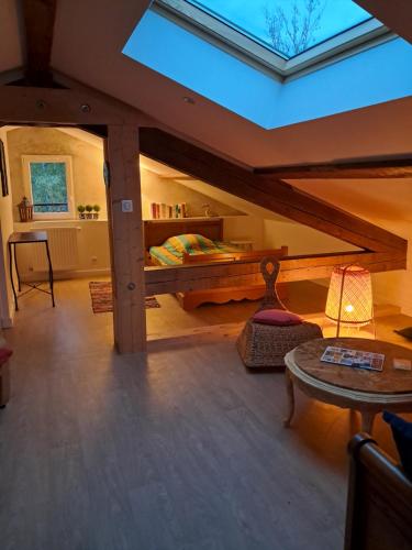 a attic room with a bed and a table at Chambres grand confort - Maison independante in Monistrol-sur-Loire