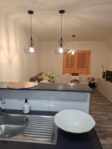 a kitchen with two pendant lights above a sink at Villa Sofia in Foz do Arelho