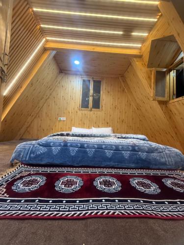 a bedroom with a large bed in a attic at Crystal peak cottage in Nagar