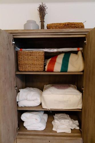 a wooden closet with towels and baskets and towels at Boxwood Haven in Moscow