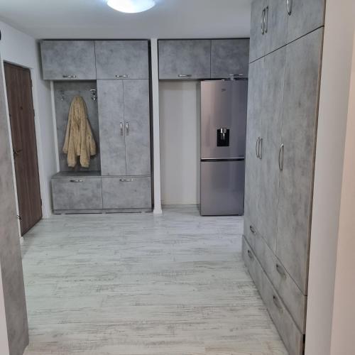 a kitchen with a stainless steel refrigerator and cabinets at Ploiesti Central Apartament in Ploieşti