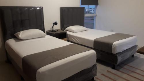 Ένα ή περισσότερα κρεβάτια σε δωμάτιο στο Arena Cielo y mar