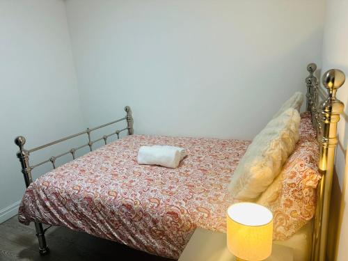 a bedroom with a bed with a pillow on it at Britlodge Living in Manchester
