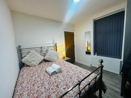 a bedroom with a bed with two pillows on it at Britlodge Living in Manchester