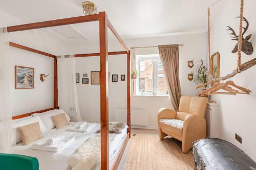 a bedroom with a canopy bed and a chair at Quirky Stay 10 min walk to city with free parking in York
