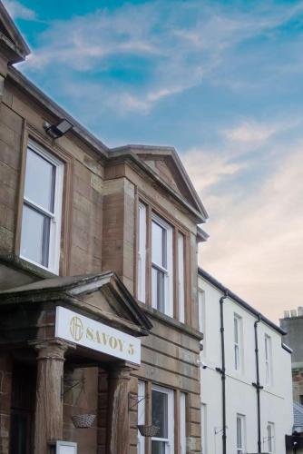 a building with a sign on the front of it at Savoy 5 in Ayr