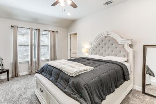 a white bedroom with a large bed and windows at Explore Baton Rouge and LSU Family Home with Yard in Baker