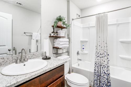 a bathroom with a sink and a toilet and a shower at Explore Baton Rouge and LSU Family Home with Yard in Baker