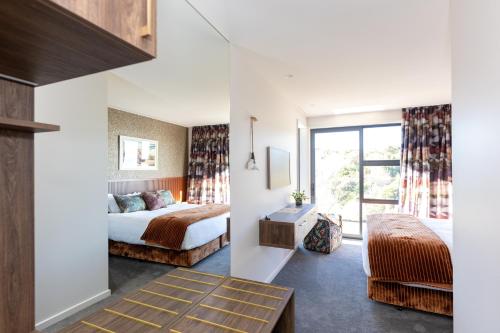 Ένα ή περισσότερα κρεβάτια σε δωμάτιο στο Tirohanga Nui