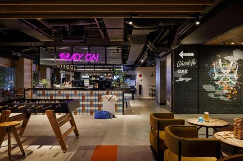 a restaurant with tables and chairs and a sign that reads victory at MOXY Tokyo Kinshicho in Tokyo