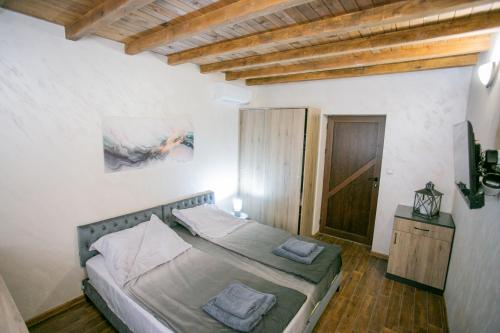 a bedroom with a bed with two pillows on it at Guest House Fortuna in Gabrovo