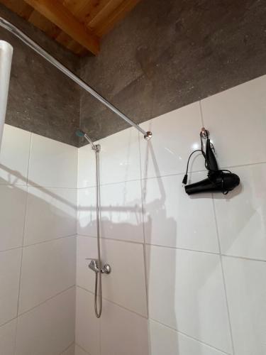 a bathroom with a shower with a phone on the wall at Cabañas BERGHAUS 