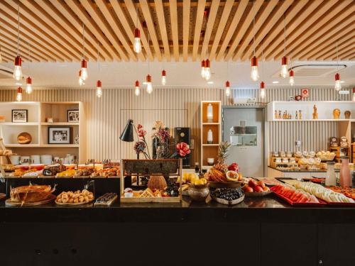 a bakery with a bunch of food on a counter at ibis Juazeiro do Norte in Juazeiro do Norte