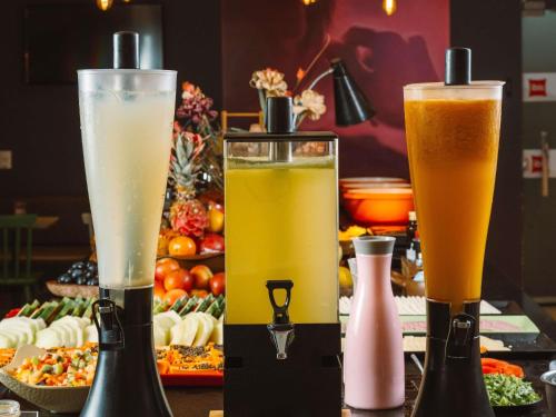 two glasses of drinks on a table with food at ibis Juazeiro do Norte in Juazeiro do Norte