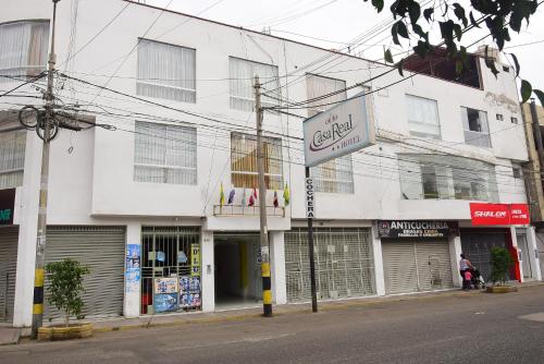a white building with a sign in front of it at Hotel Casa Real Tacna in Tacna