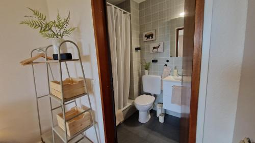 a bathroom with a toilet and a sink at Cozy Schwarzwaldnest für 2! in Schönwald