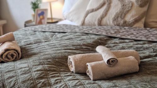 a pile of rolled towels on a bed at Cozy Schwarzwaldnest für 2! in Schönwald