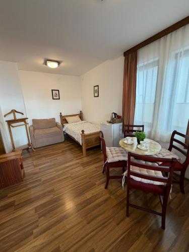 a living room with a table and a bed at Villa Srma OHRİD in Ohrid