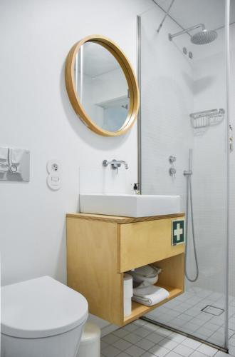 a bathroom with a sink and a mirror at I Loft Porto in Porto