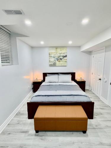 a bedroom with a large bed and two night stands at Modern Cozy Basement Suite Free Parking in Brampton