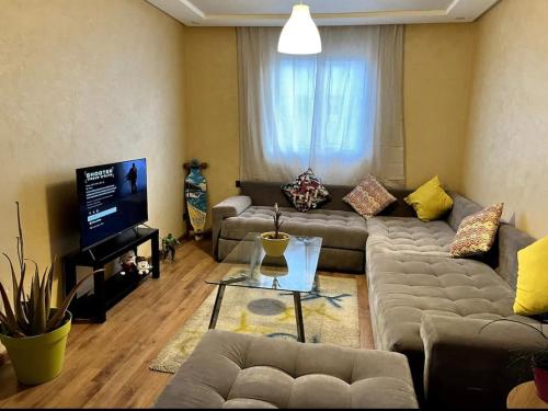 Una sala de estar con dos sofás y un televisor. en Moderne appartement in a good location, en Casablanca