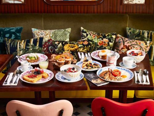 a table with plates of food on it at Mama Shelter Roma in Rome