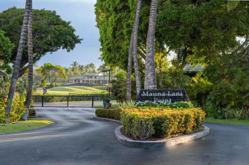 a sign at the end of a road with palm trees at Mauna Lani Point in Waikoloa