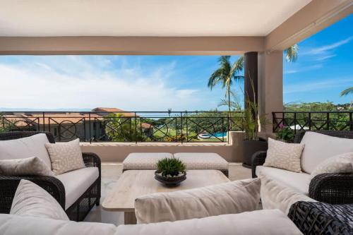 a living room with couches and a view of the ocean at Luxury- HDM Condo Concierge Golf Cart in Punta Mita