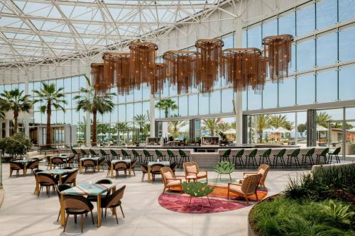 a lobby with chairs and tables in a building at Gaylord Pacific Resort & Convention Center in Chula Vista