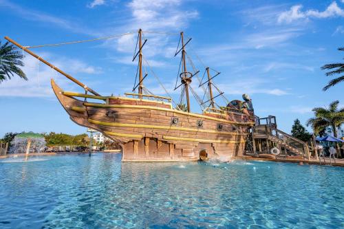 a wooden boat in the water at a theme park at 2BR Fireworks View with Pool & Spa 5 Minutes to Disney in Vineland