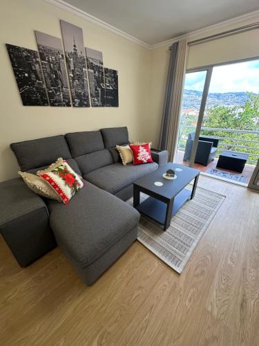 a living room with a couch and a table at Heart of Madeira Island in Funchal