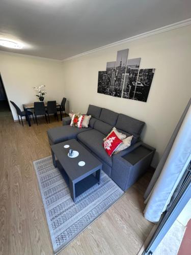 a living room with a couch and a table at Heart of Madeira Island in Funchal
