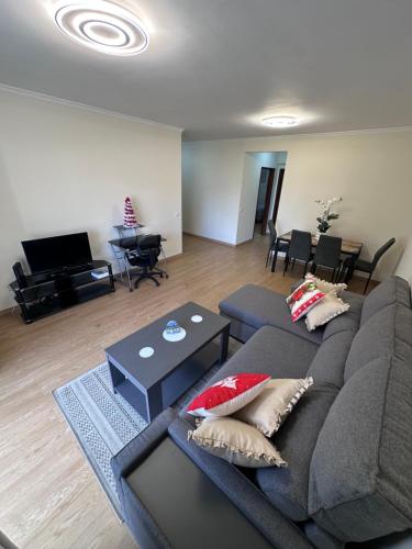 a living room with a couch and a table at Heart of Madeira Island in Funchal