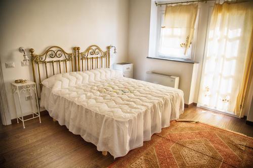 a bedroom with a large bed with a white blanket at Don Carlo Agriturismo di Charme Bio in Le Pioppe