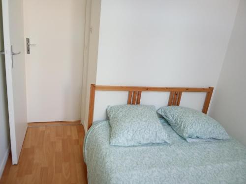 un letto con due cuscini in una piccola stanza di Lille Centre gare Lille Europe a Lille