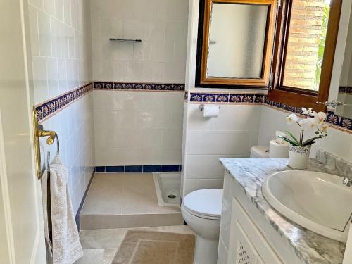 a bathroom with a toilet and a sink at Penthouse Apartment Orihuela Costa in Orihuela Costa