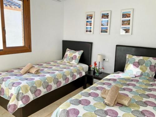 two beds sitting next to each other in a room at Penthouse Apartment Orihuela Costa in Orihuela Costa