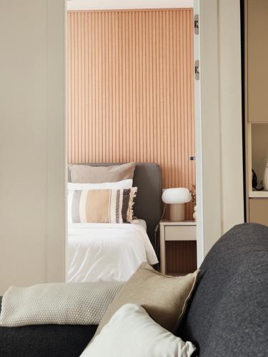 a bedroom with two beds and a mirror at Casa Estío - Renovated 1st line sea view apartment, pool access, AC - Calpe Costa Blanca in Ifach