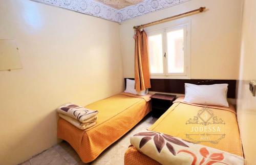 Postel nebo postele na pokoji v ubytování Hôtel Jodesa