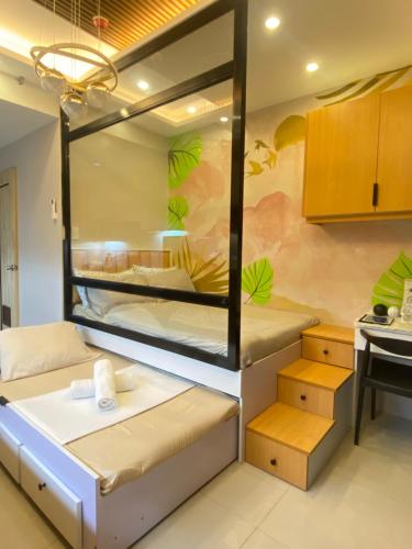 a room with two bunk beds and a table at Inspiria Condominium in Davao City
