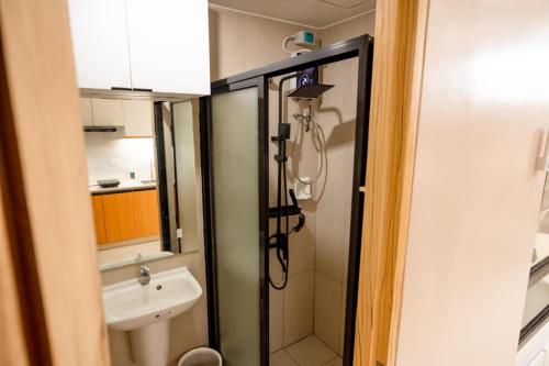 a bathroom with a shower and a sink at Inspiria Condominium in Davao City