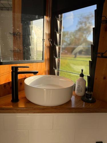 a white sink in a window in a bathroom at Sol On Loten in Mitchells Island
