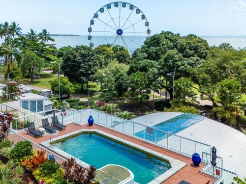 a view of a pool and a ferris wheel at BreakFree Royal Harbour in Cairns
