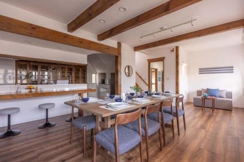 a large dining room with a long table and chairs at Ito Orange Beach Villa - Ocean View & Private Onsen in Ito