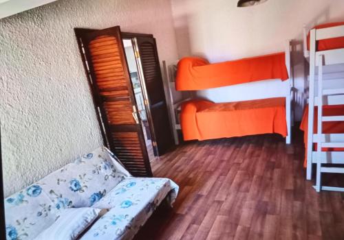 a room with two bunk beds and a couch at Lunita in Costa Azul