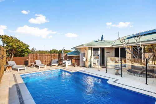 a swimming pool in the backyard of a house at 5BR Beachside Home with Pool, Park Access in Perth