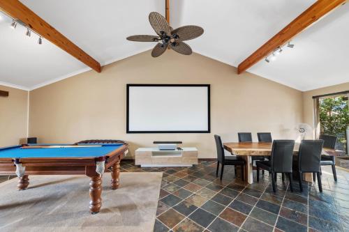 a living room with a ping pong table and a ceiling fan at 5BR Beachside Home with Pool, Park Access in Perth