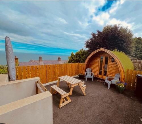 a backyard with a gazebo and a table and chairs at Smugglers Cove in Widows Row